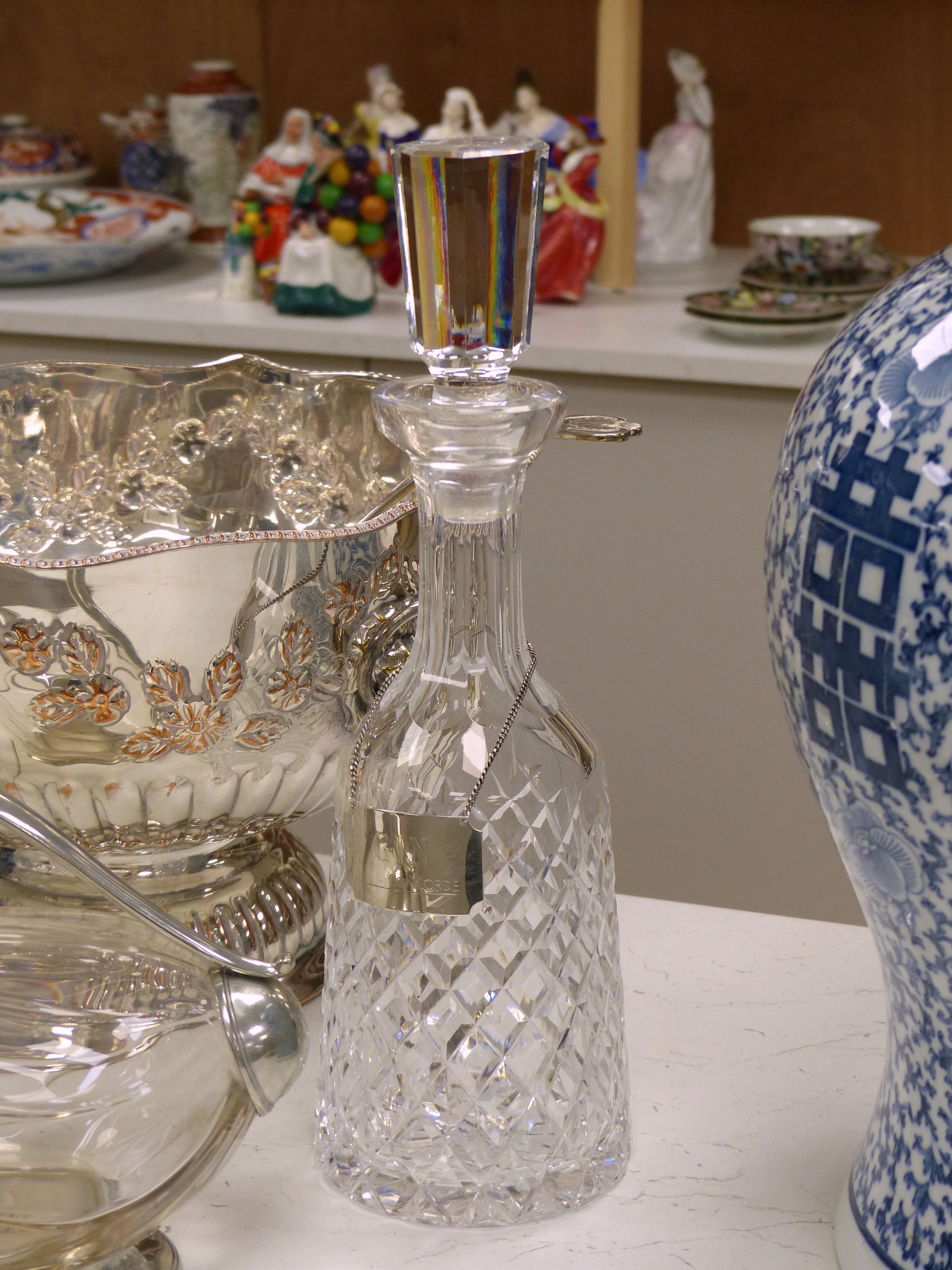 Two cut glass decanters (one silver-mounted), two silver Whisky and Gin labels, an 'Etains du Manoir' duck shaped wine carafe and two other items